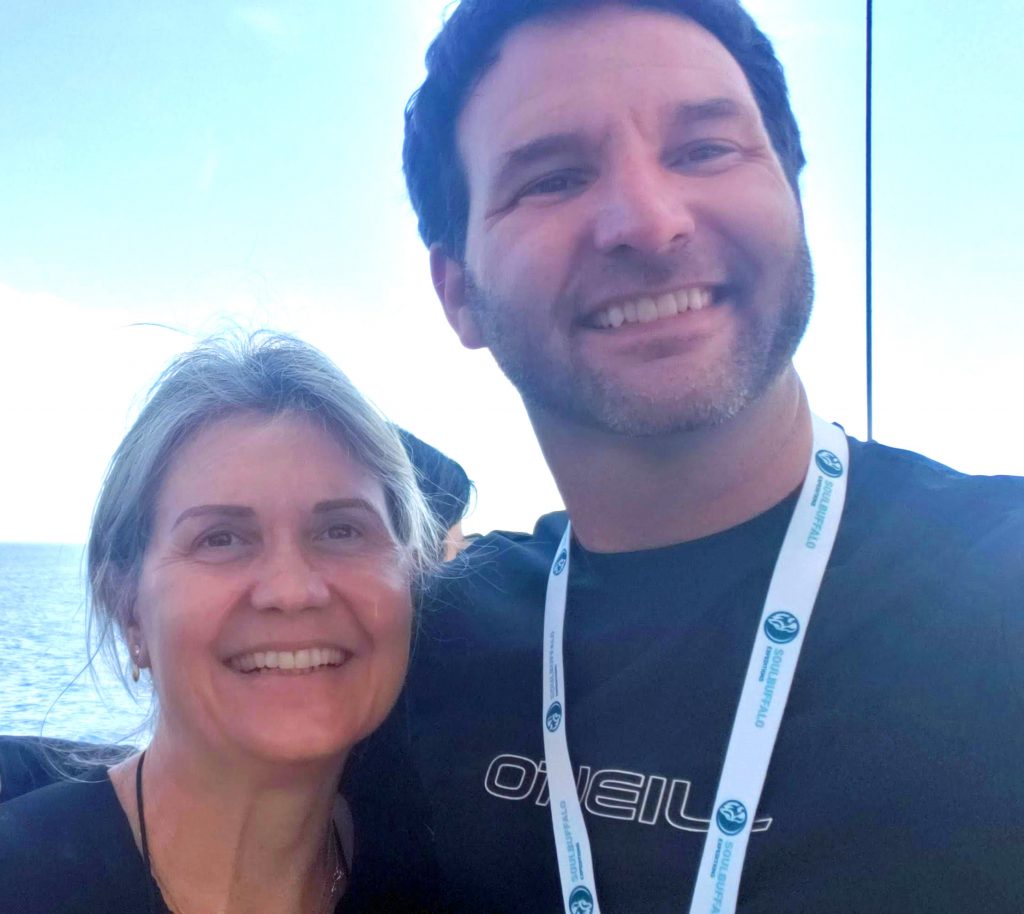 Two expedition members standing together on the deck of the ship.